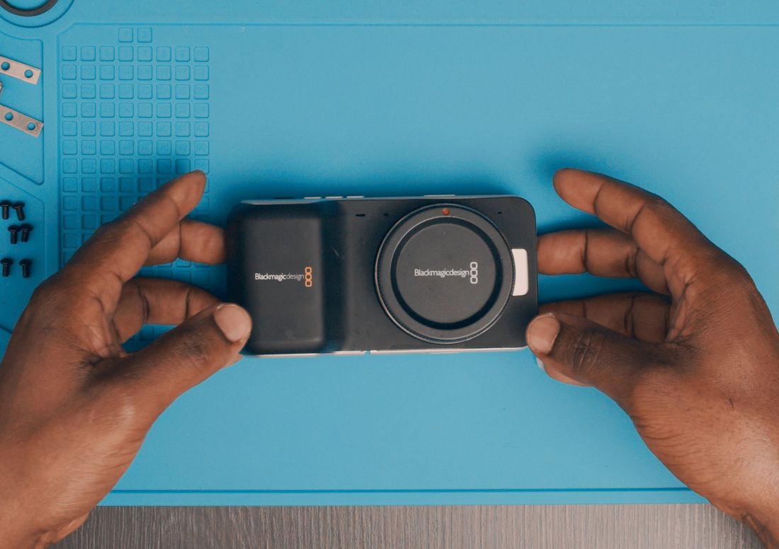Lift the camera from the bottom edges to keep it together.