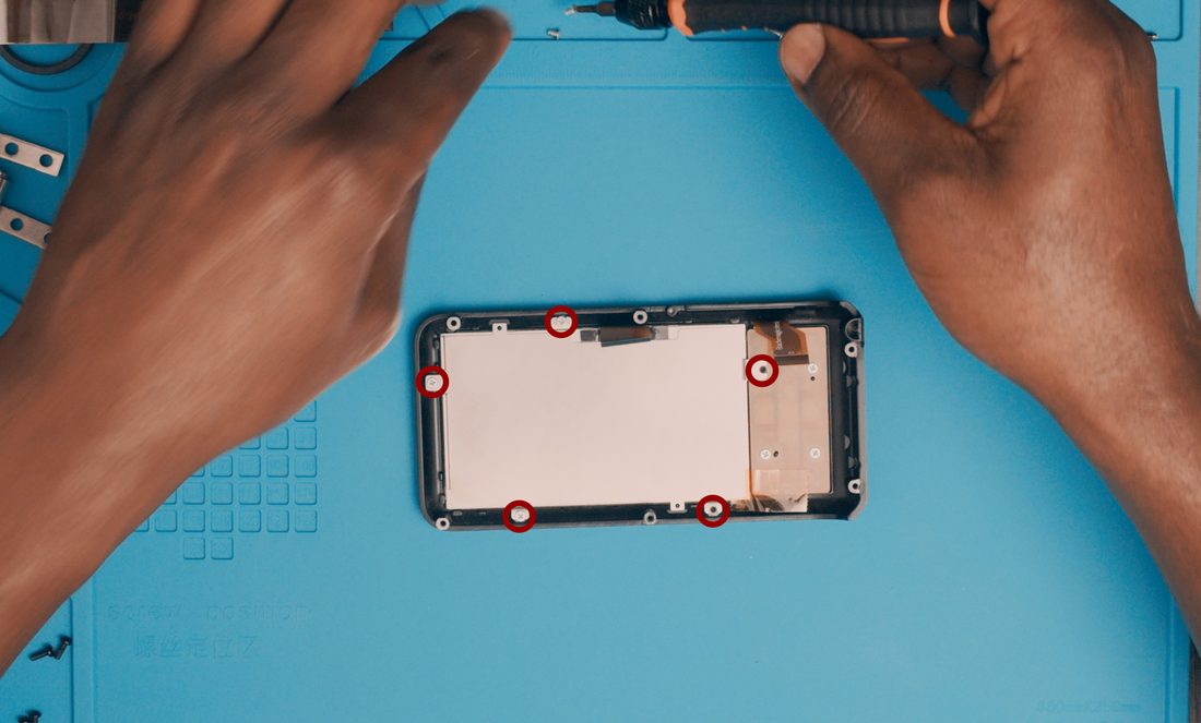 Remove the screws holding the metal plate that secures the screen in place.