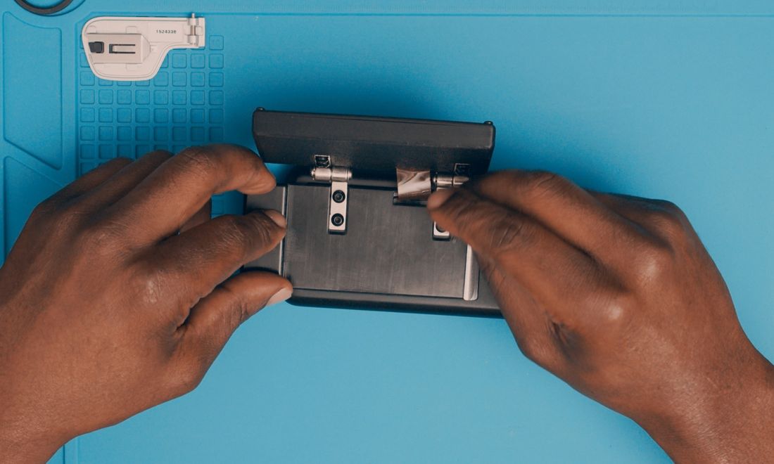 Feed the FPC through the backplate slot before lining up the hinge holes.