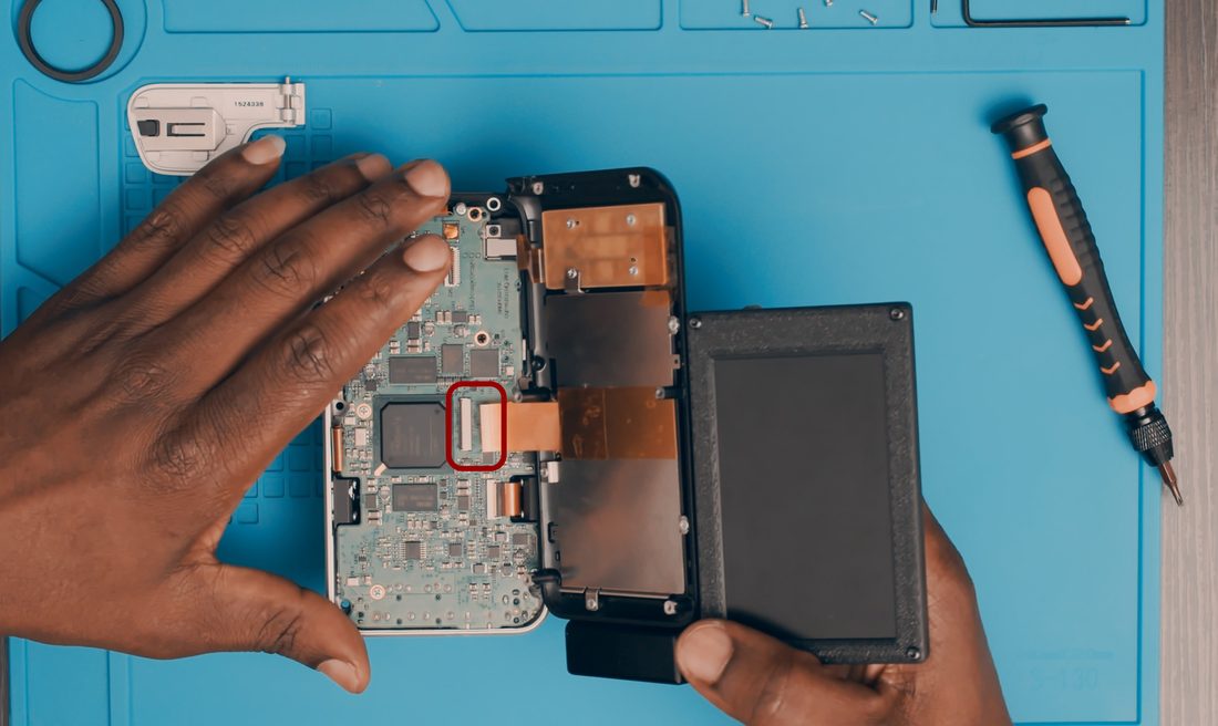 Reconnect the LCD FPC and secure it with the locking tab.